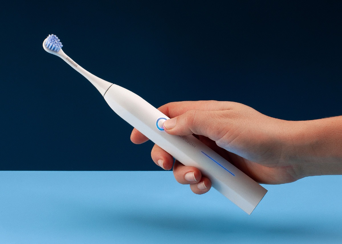A lifestyle photo of a hand holding Curaprox Sonic electric toothbrush.