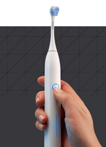 A hand holding Curaprox Sonic toothbrush with black box and a polygon pattern in the background.