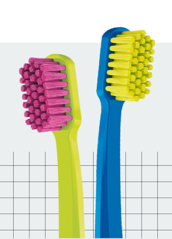 Cropped photo of two colorful Curaprox toothbrushes with a black grid pattern in the background.